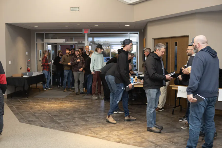 Men arriving and checking in for the 2025 conference