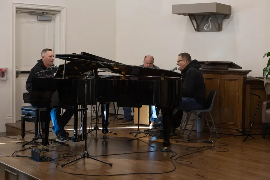 Musicians leading worship around the grand piano
