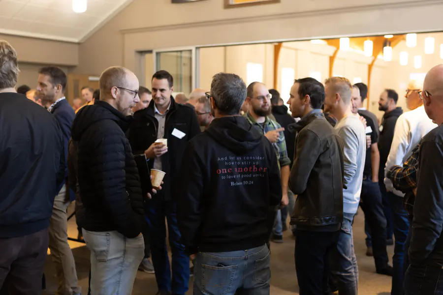 Attendees gathering beneath the 2025 One Another theme