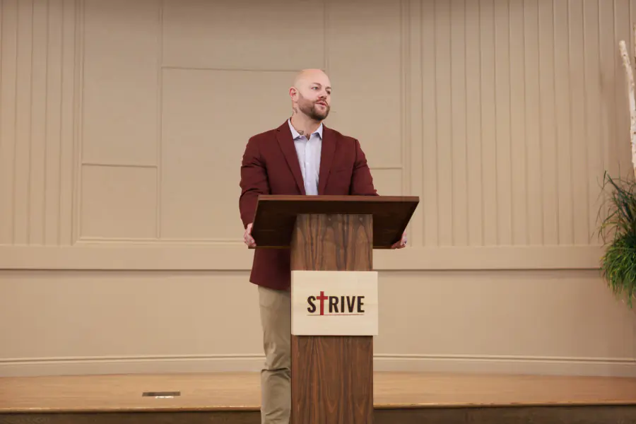 A speaker addressing the 2025 Strive conference